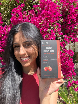 Founder holding Gobbi savory energy drink tomato harvest box