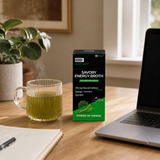 GOBBi Power Up Greens Energy Broth and a warm cup beside a laptop