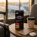 GOBBi Energy Broth Variety Pack with a takeaway cup in an airport lounge